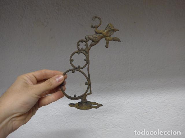 Antig&uuml;edades: Antigua base de metal de principios s.XX con angelito o querubin, a identificar el uso.