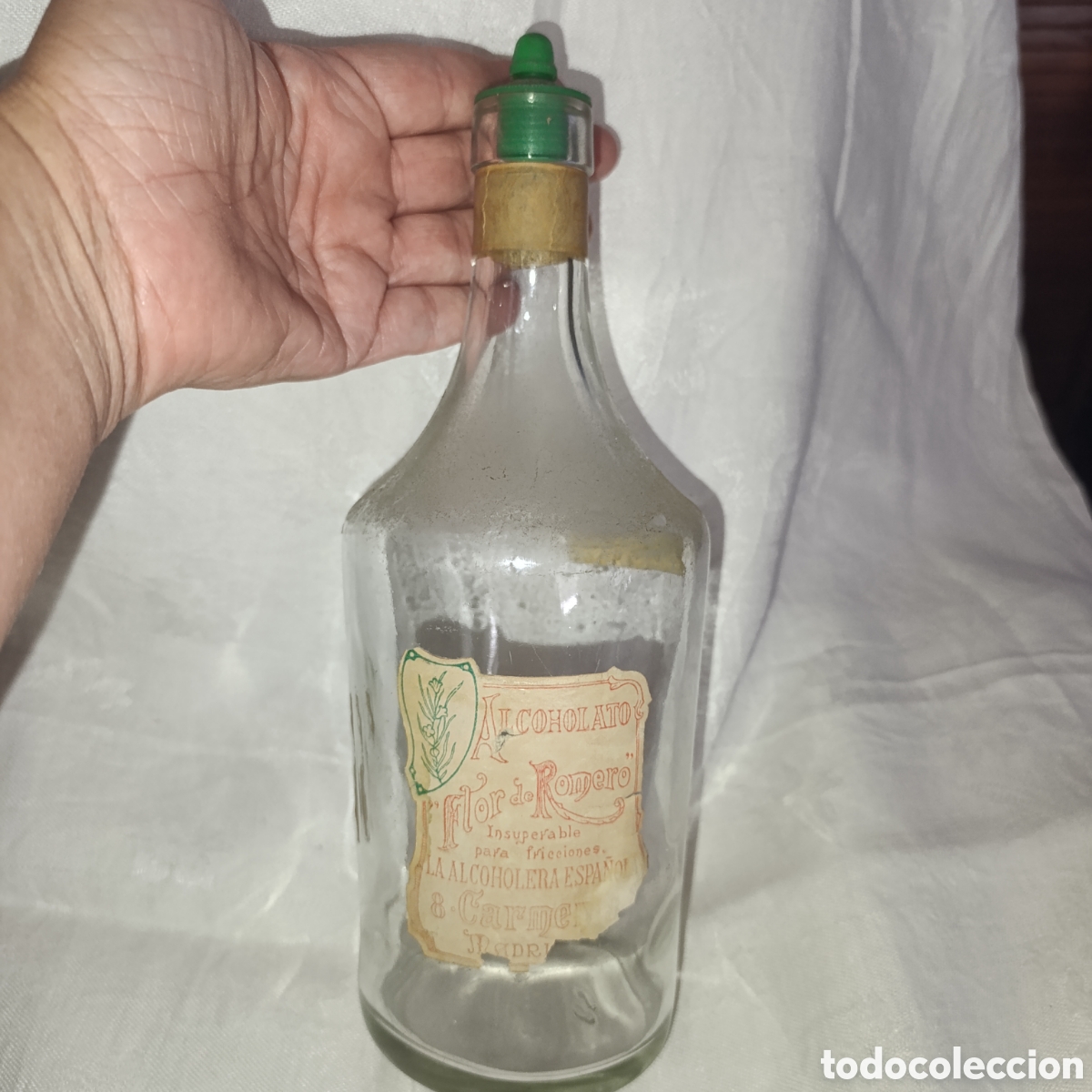 Antig&uuml;edades: La Alcoholera Espa&ntilde;ola,Antigua botella de Alcoholato de Flor de Romero,impuesto de lujo met&aacute;lico