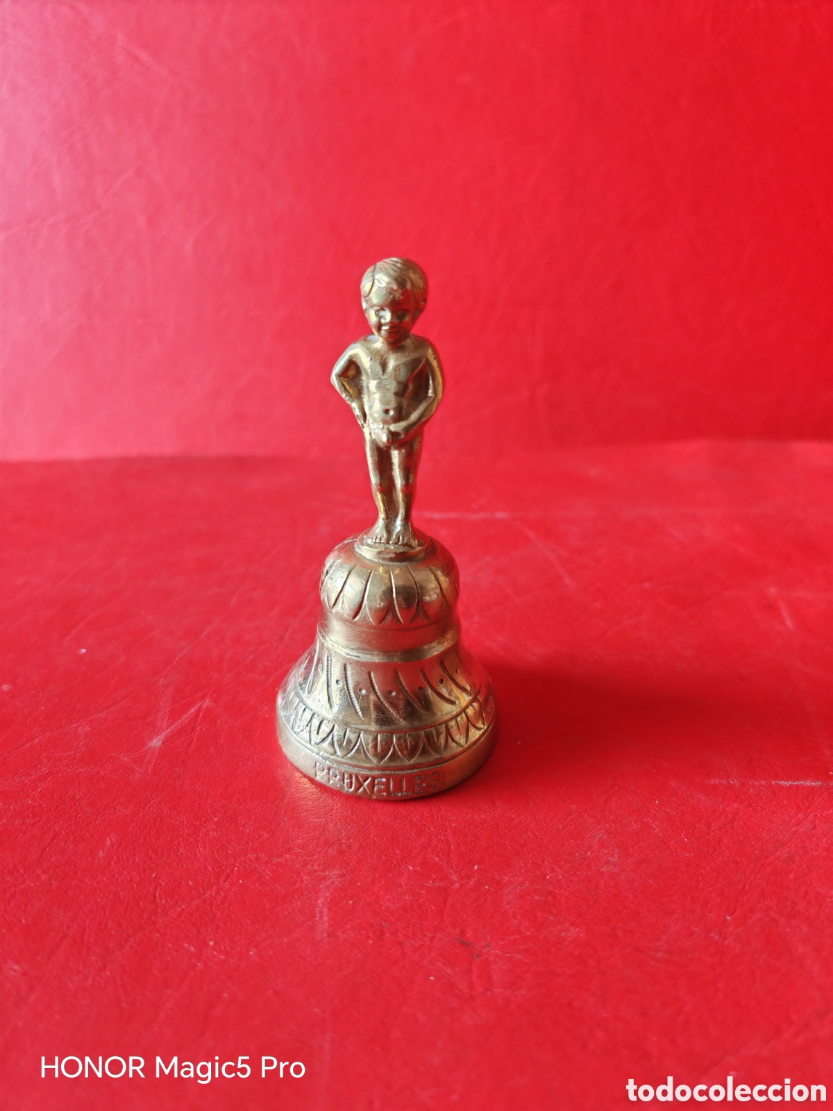 Antig&uuml;edades: Campana de bronce-BRUXELLES, pesa 220 gramos, campanilla