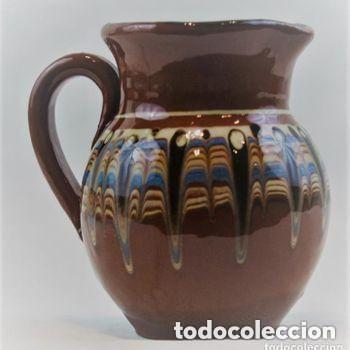Antiguidades: Jarra de cer&aacute;mica popular, esmaltada con franja de colores azules, ocres y blancos en fondo marr&oacute;n.