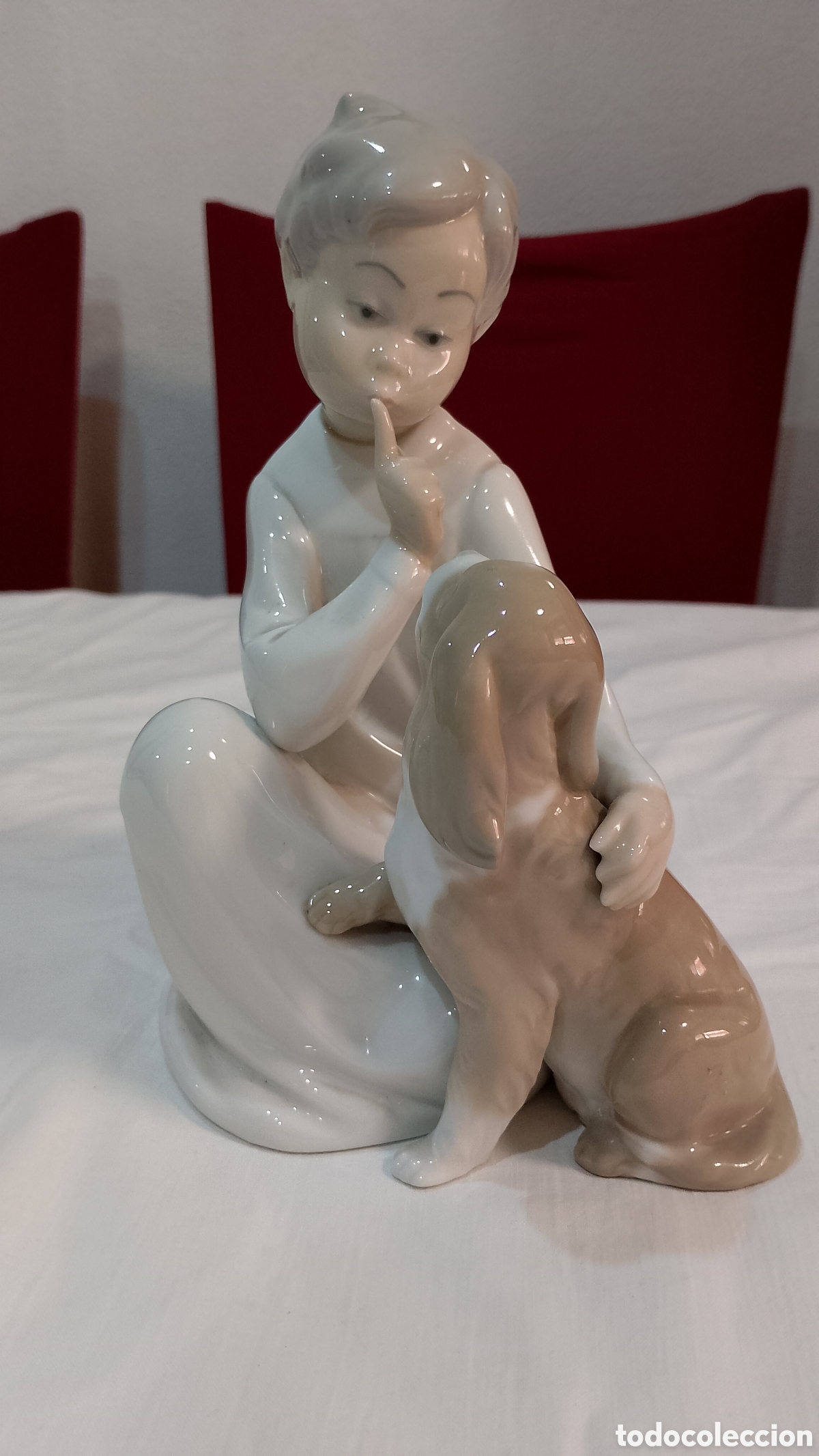 Antig&uuml;edades: Figura de porcelana lladro ni&ntilde;o con perro