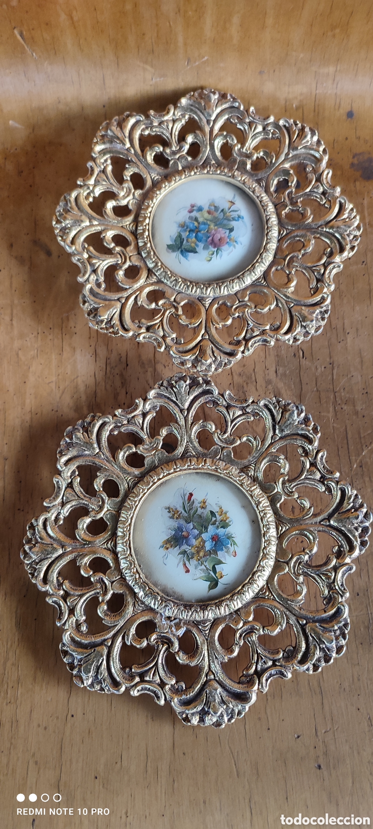 Antig&uuml;edades: Dos platos decorativos de lat&oacute;n con decoraci&oacute;n central de porcelana.