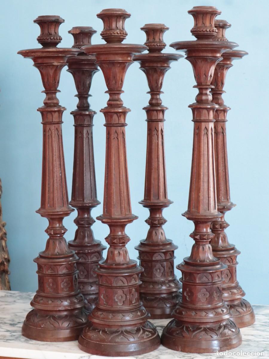 Antig&uuml;edades: Conjunto de seis candeleros de altar elaborados en madera tallada. Pps. S. XX. Miden 68 cm de alt.