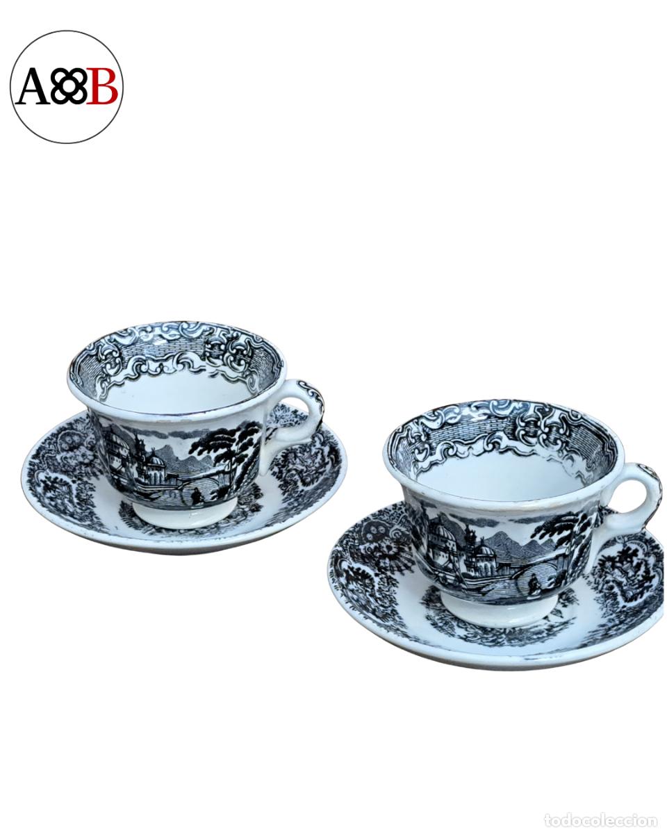 Antig&uuml;edades: Par de tazas y platillos porcelana Sevilla paisaje negro