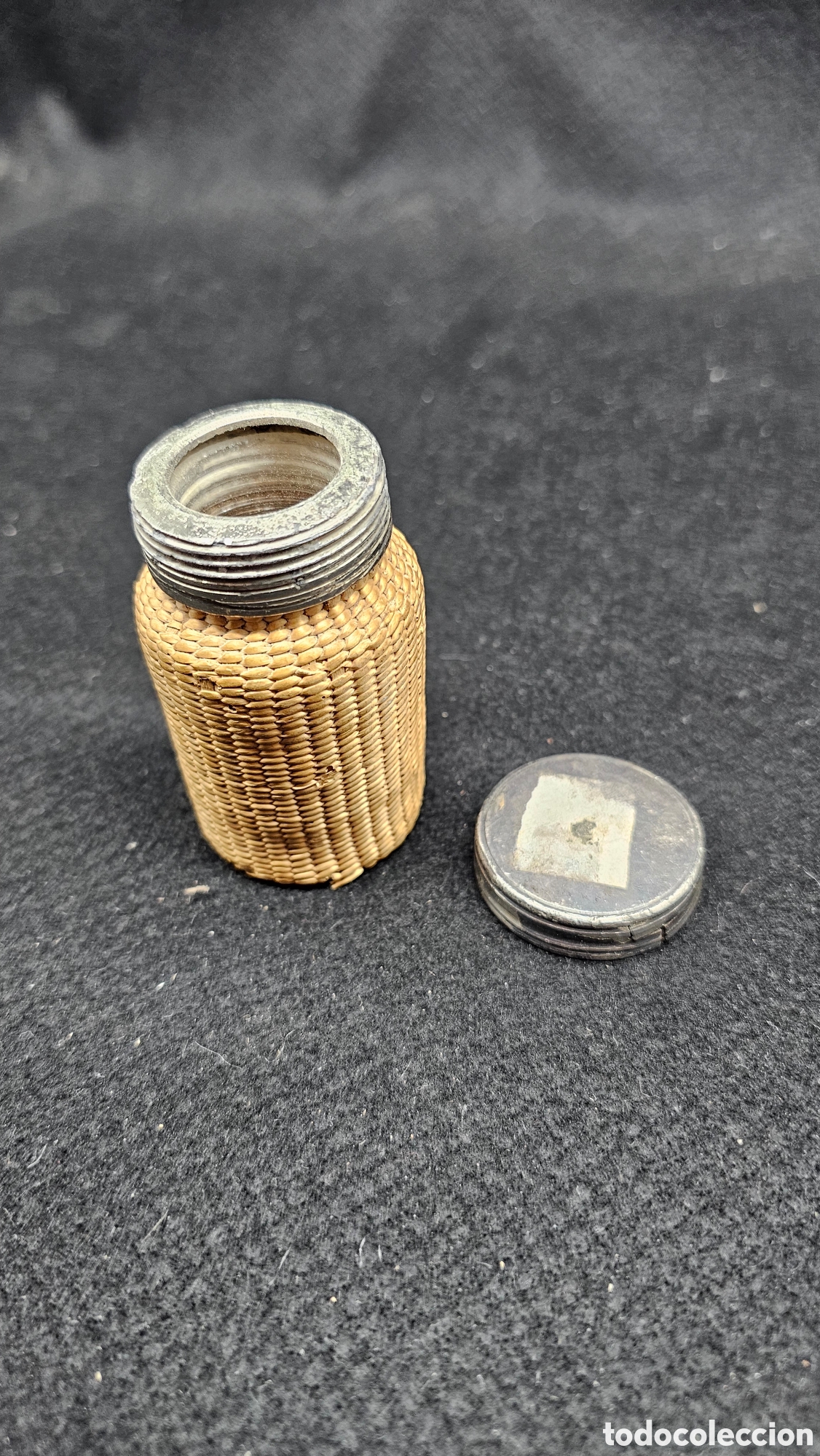 Antig&uuml;edades: peque&ntilde;o frasco o botella vintage de vidrio, recubierto de fibra vegetal tejida a mano