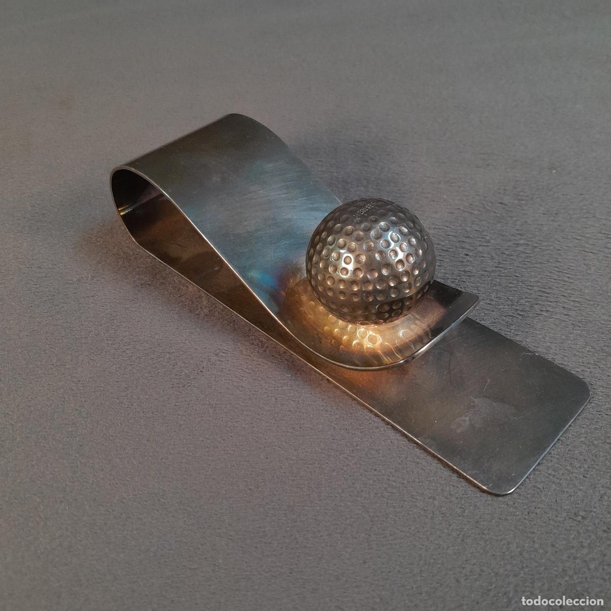 Antiguidades: PINZA PARA BILLETES CON BOLA DE GOLF. HERM&Egrave;S. 1970 - 1980