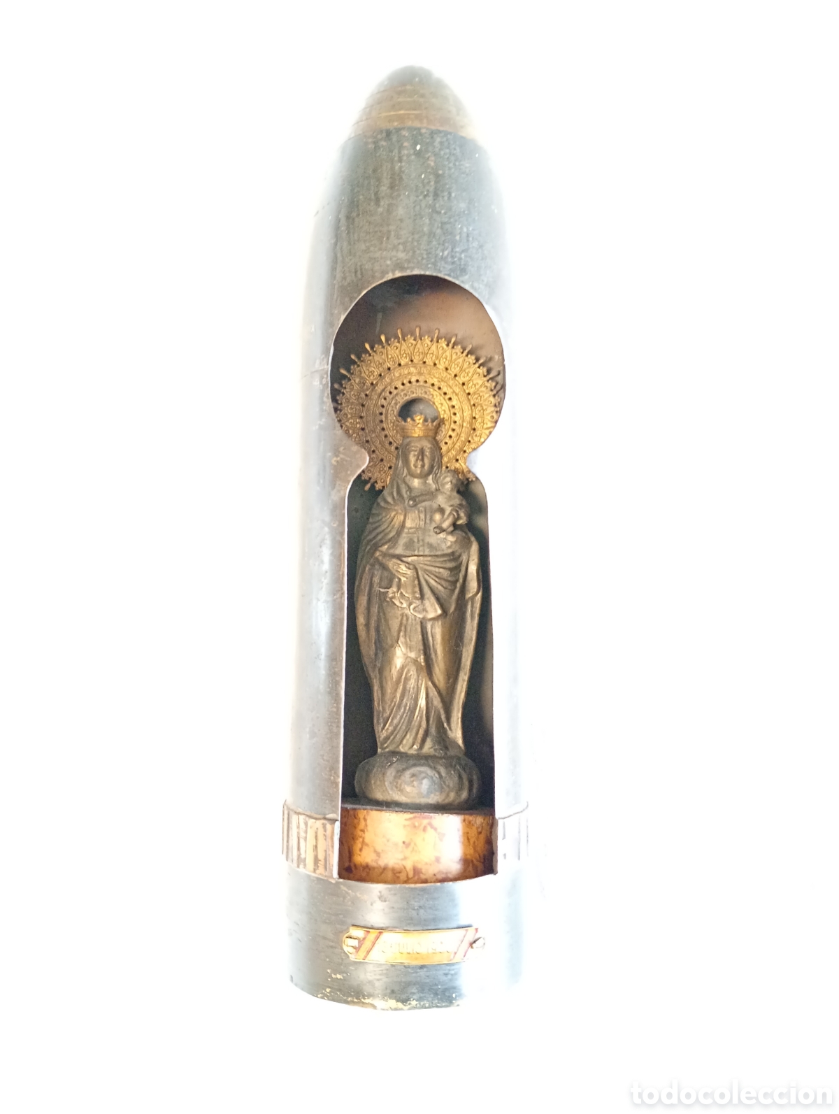 Antig&uuml;edades: Antigua hornacina met&aacute;lica proyectil de guerra con imagen met&aacute;lica Virgen del Pilar sobre columna.