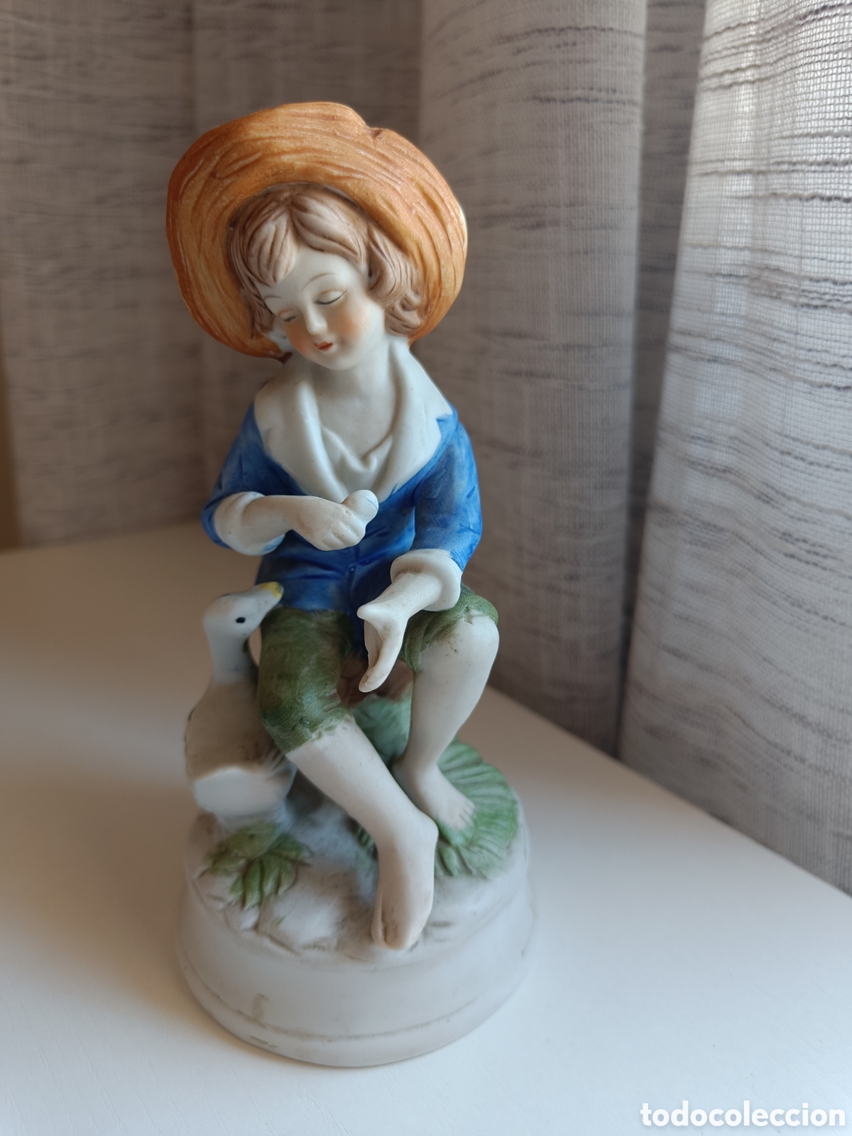 Arte: Figura porcelana ni&ntilde;o con ganso