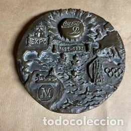 Arte: Coca Cola. Medall&oacute;n bronce 1492-1992