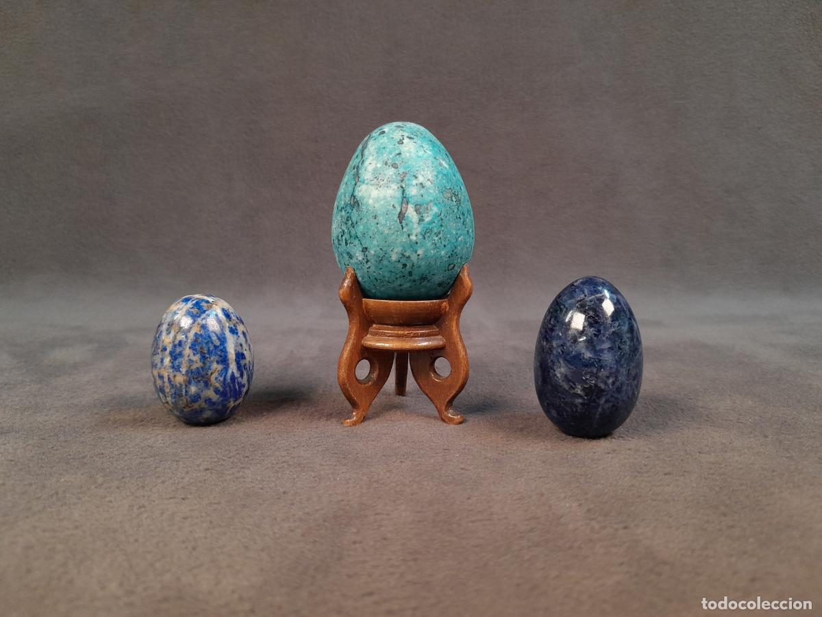 Arte: LOTE DE TRES HUEVOS EN PIEDRAS DURAS EN GAMA DE AZULES CON PEANA DE MADERA NOBLE. SIGLO XX.