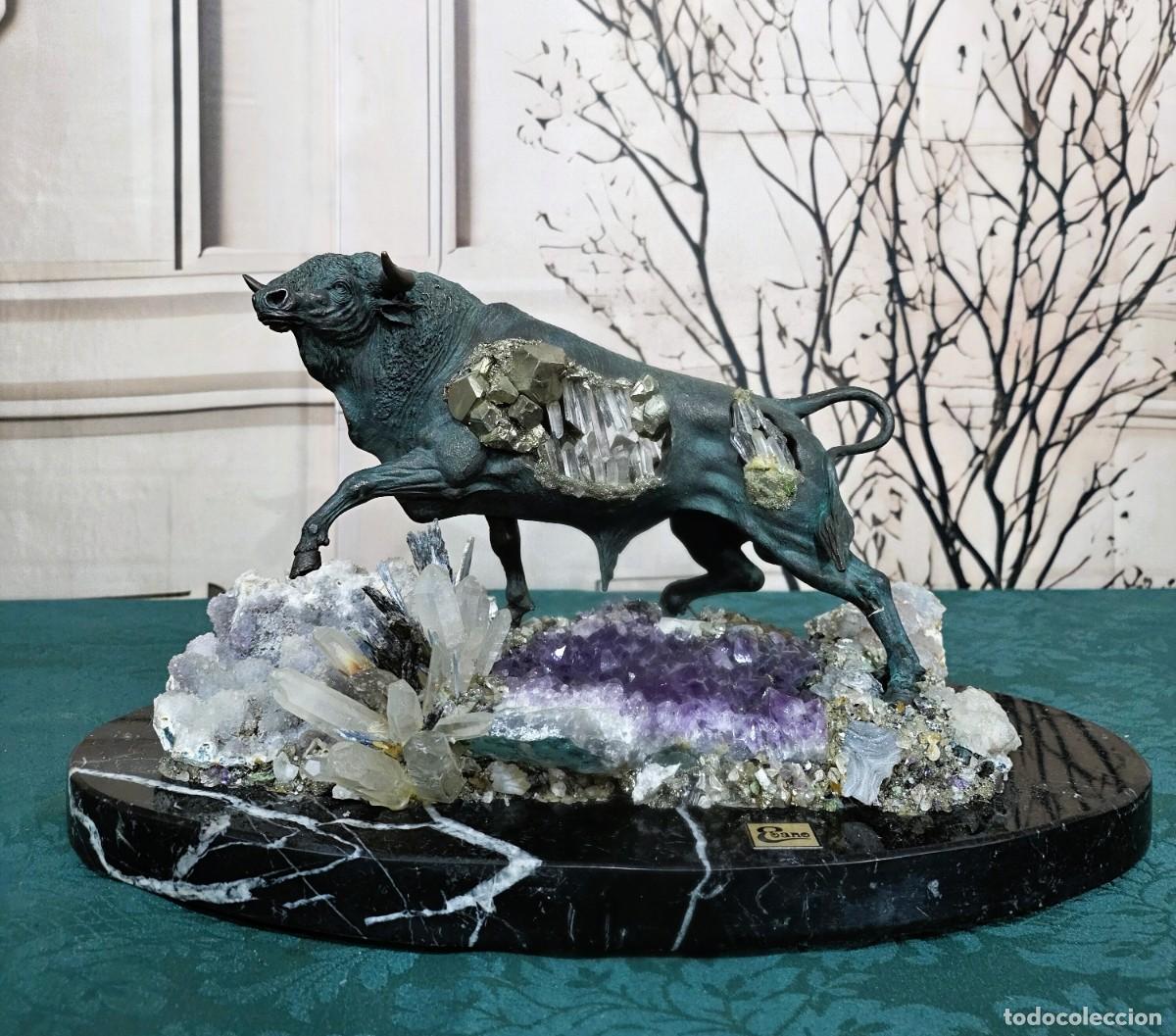 Arte: Escultura de un toro en bronce patinado sobre una base de m&aacute;rmol negro