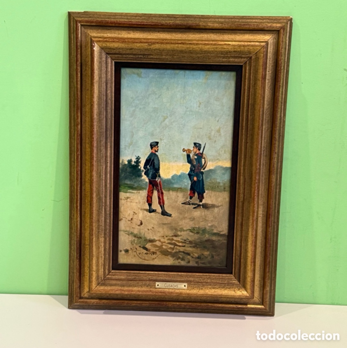 Arte: &Oacute;leo militar firmado Cusachs sobre tablex con marco y placa identificativa.