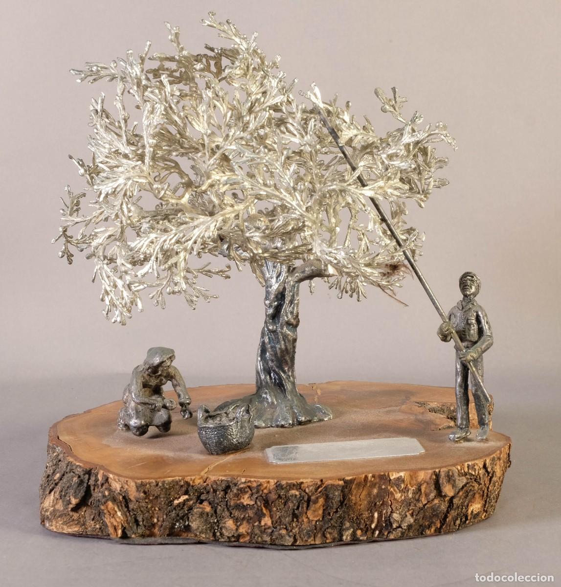 Arte: Escultura de Recuerdo en metal sobre base de tronco.