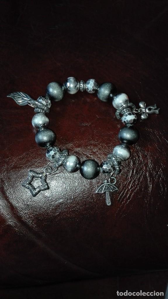 Joalharia: Pulsera de bolas,paraguas,estrella,lazo y hoja.