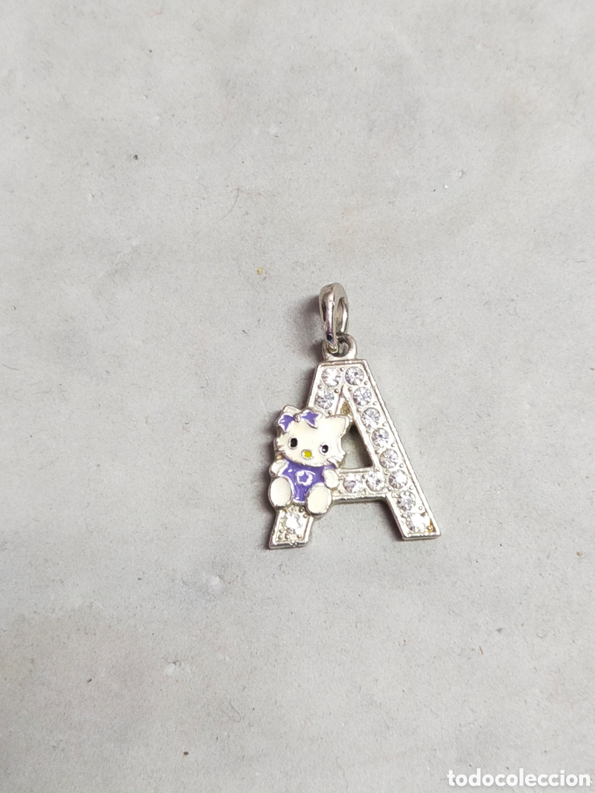 Schmuck: COLGATE EN FORMA DE A, METAL.