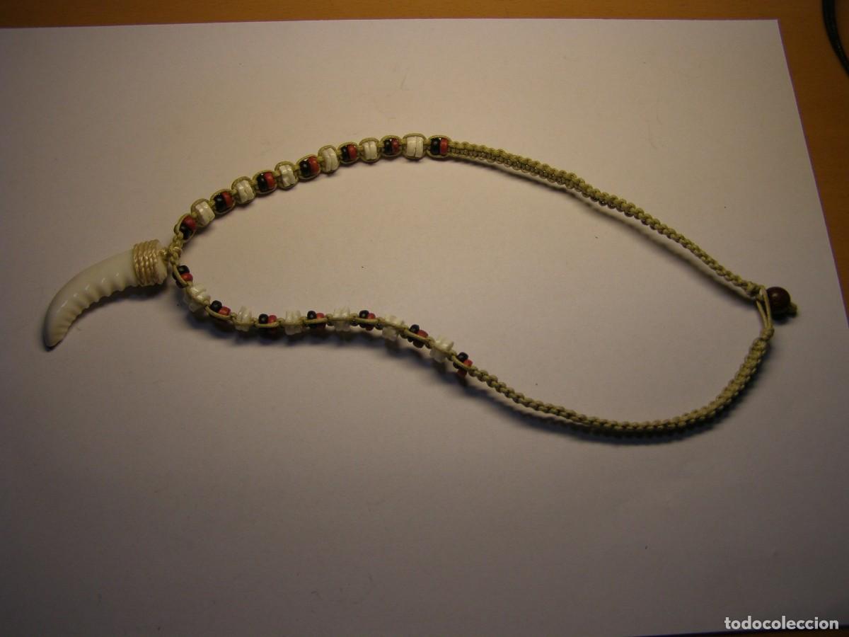 Joaillerie: bonito colgante tipo diente, fabricado con conchas.