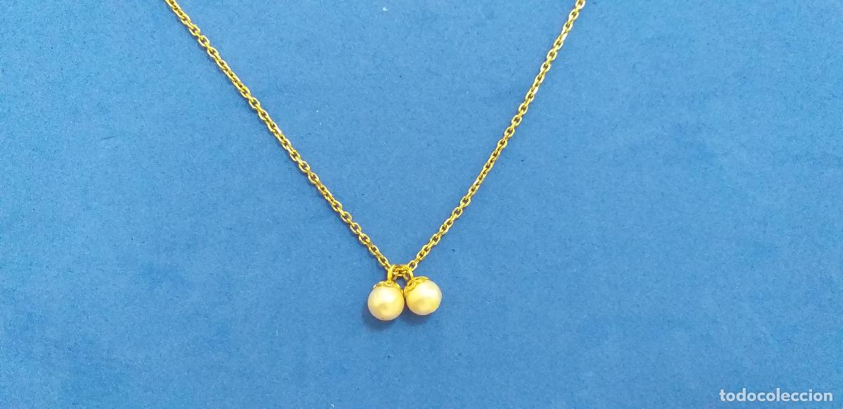 Joyeria: Cadena dorada. Con colgante de dos perlas de IMITACION. Largo 42 cm.