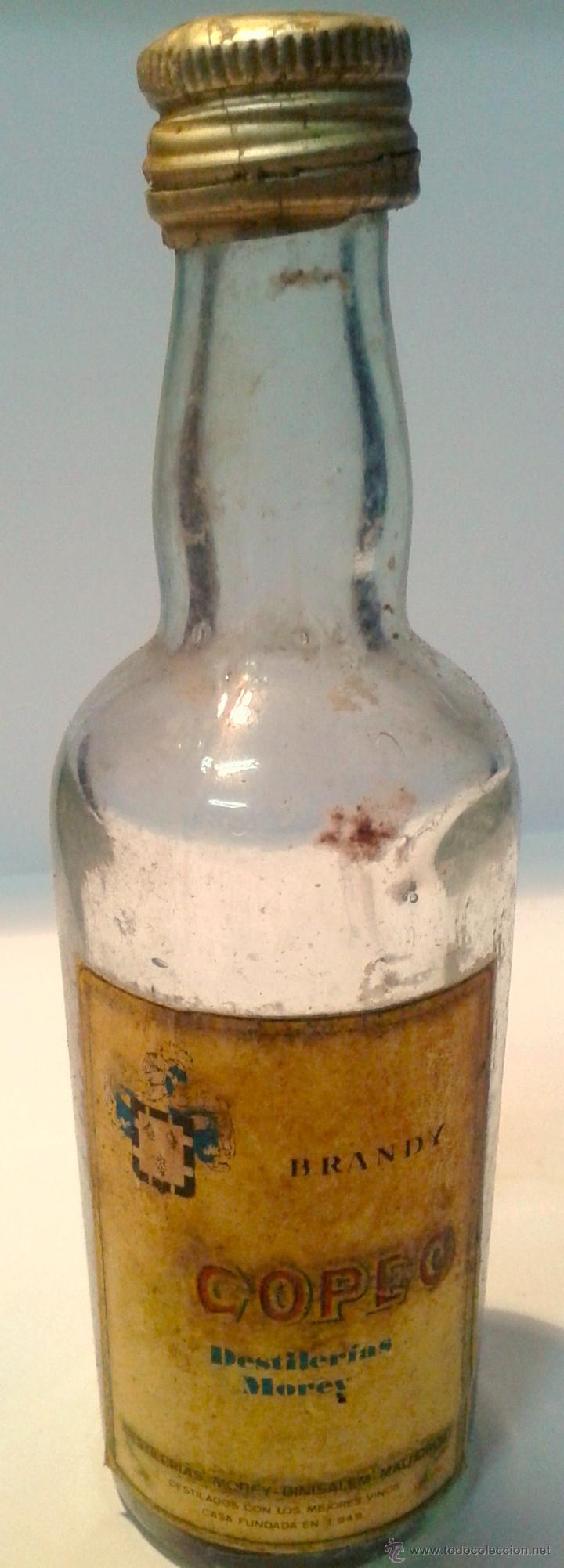 Botellas antiguas: MINI BOTELLA-BRANDY COPPO- LA BOTELLA  ESTA EVAPORADA- - Foto 1