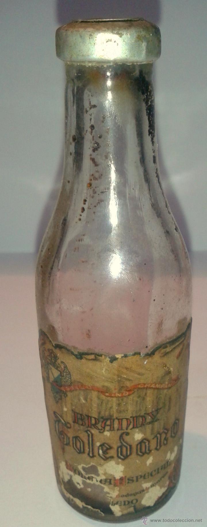 Botellas antiguas: MINI BOTELLA DE BRANDY TOLEDANO-LA BOTELLA ESTA EVAPORADA- - Foto 1