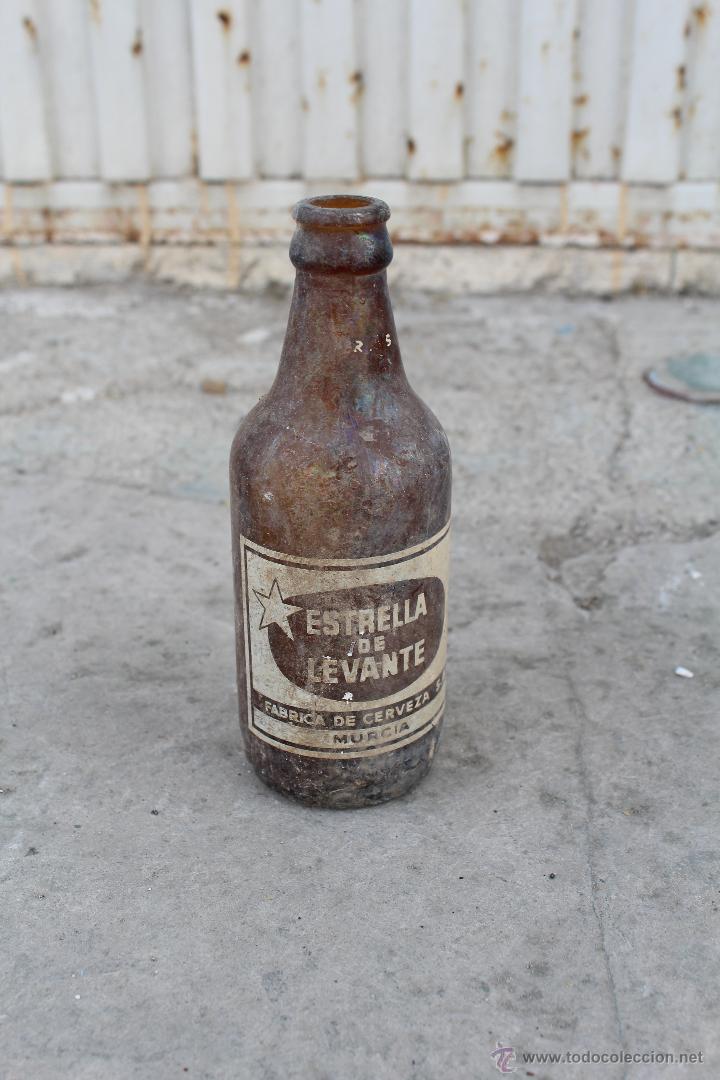 Botellas antiguas: BOTELLA TERCIO ESTRELLA DE LEVANTE - Foto 1
