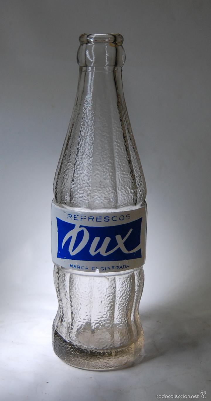 Botellas antiguas: BOTELLA DE ZUMO DUX - Foto 1