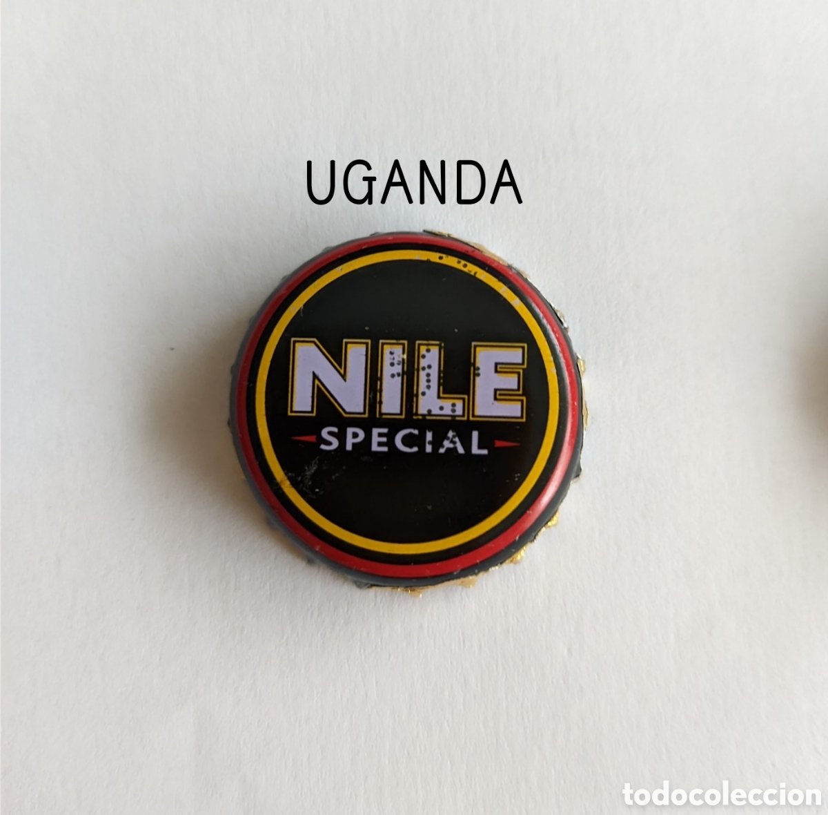 Botellas antiguas: Chapa tap&oacute;n corona de Uganda - Foto 1