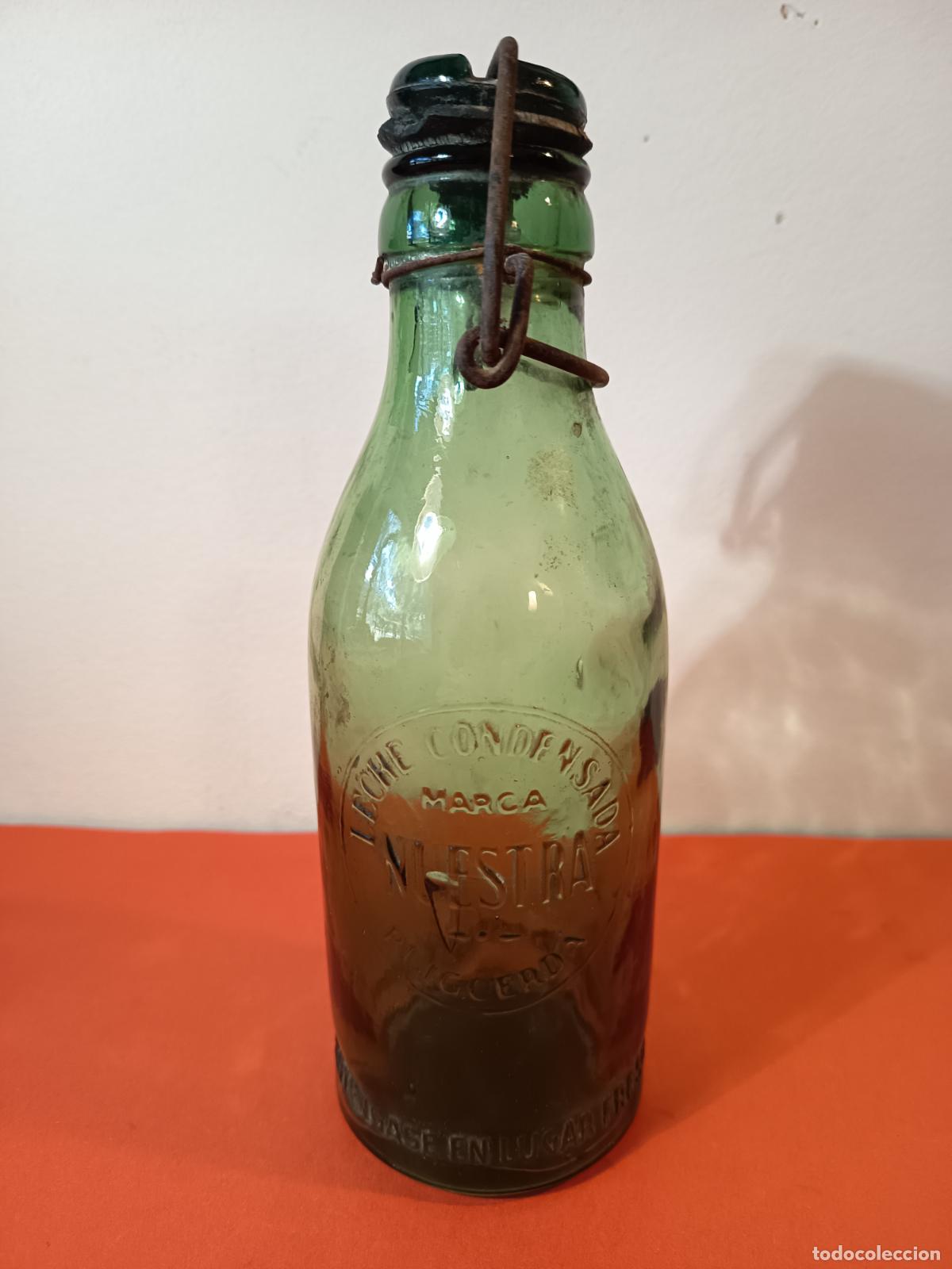 Botellas antiguas: BOTELLA DE LECHE CONDENSADA MARCA NUESTRA PUIGCERDA - Foto 2