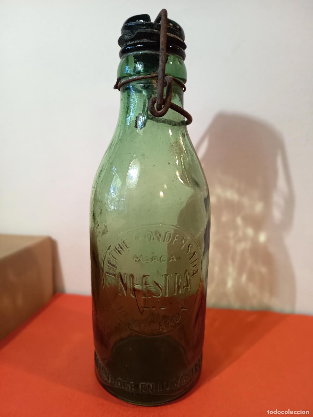 Botellas antiguas: BOTELLA DE LECHE CONDENSADA MARCA NUESTRA PUIGCERDA - Foto 3