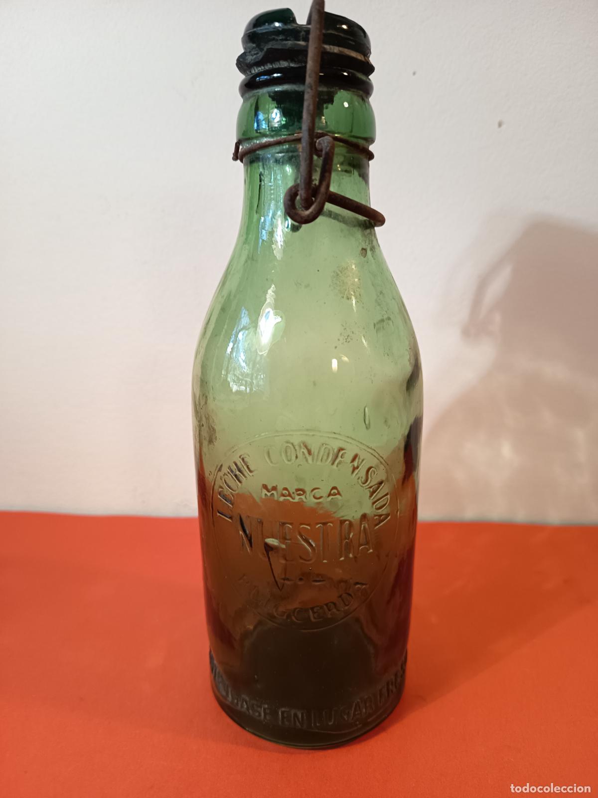 Botellas antiguas: BOTELLA DE LECHE CONDENSADA MARCA NUESTRA PUIGCERDA - Foto 1
