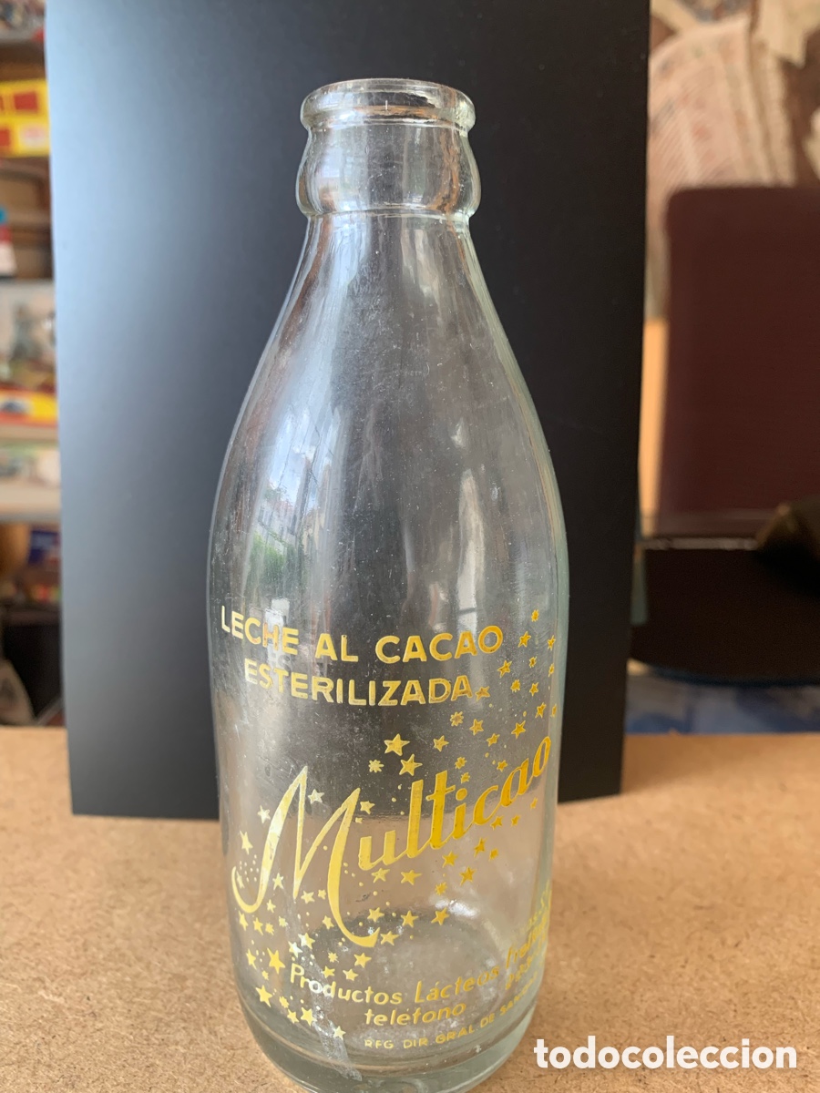 Botellas antiguas: BOTELLA DE LECHE AL CACAO ESTERILIZADA MULTICAO. A&Ntilde;OS 60/70.