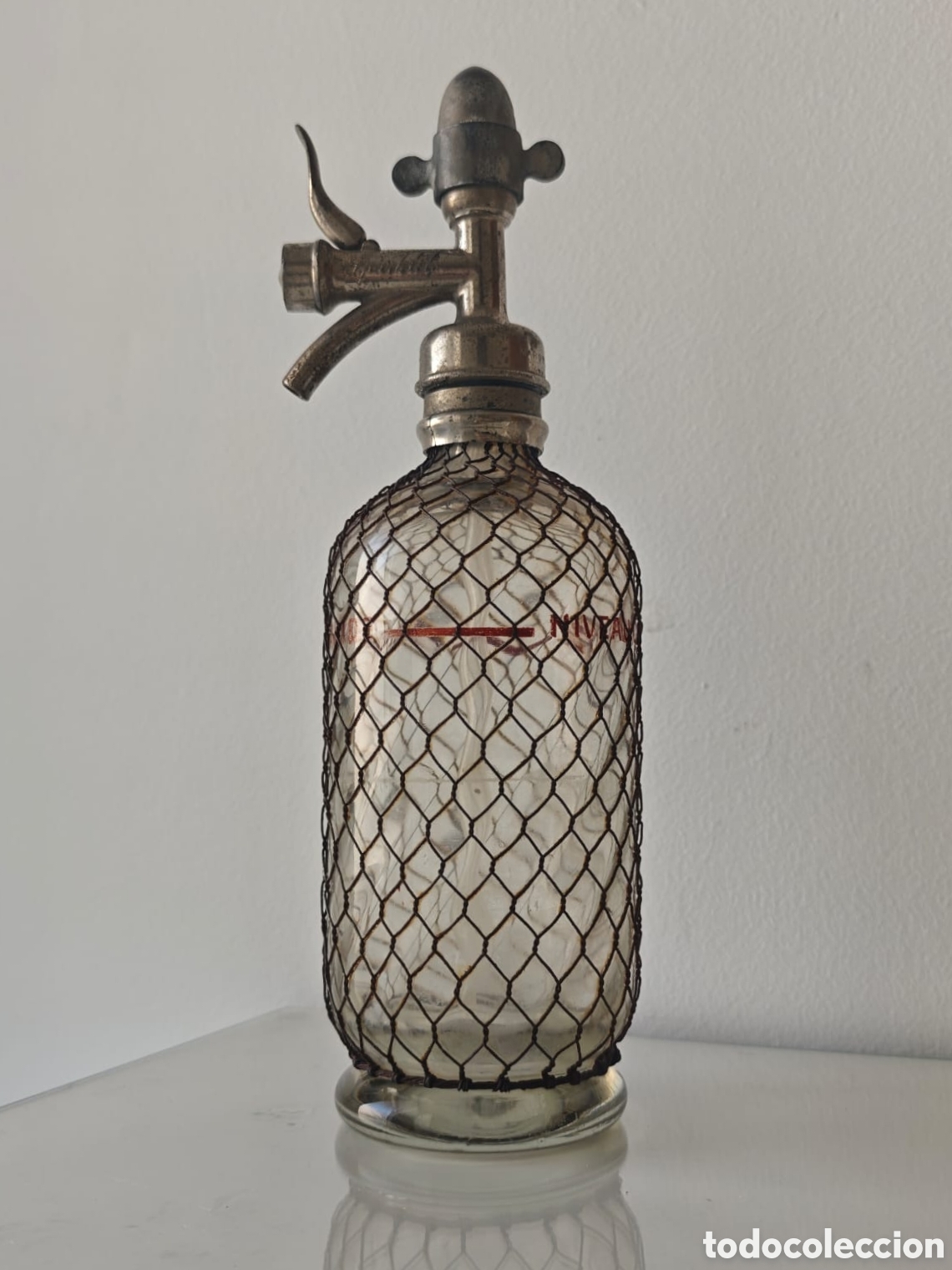 Botellas antiguas: Antiguo Sif&oacute;n Franc&eacute;s. SPARKLETS. Malla Met&aacute;lica, Tap&oacute;n de Plomo. Transparente. Siglo XX. Seltzogene