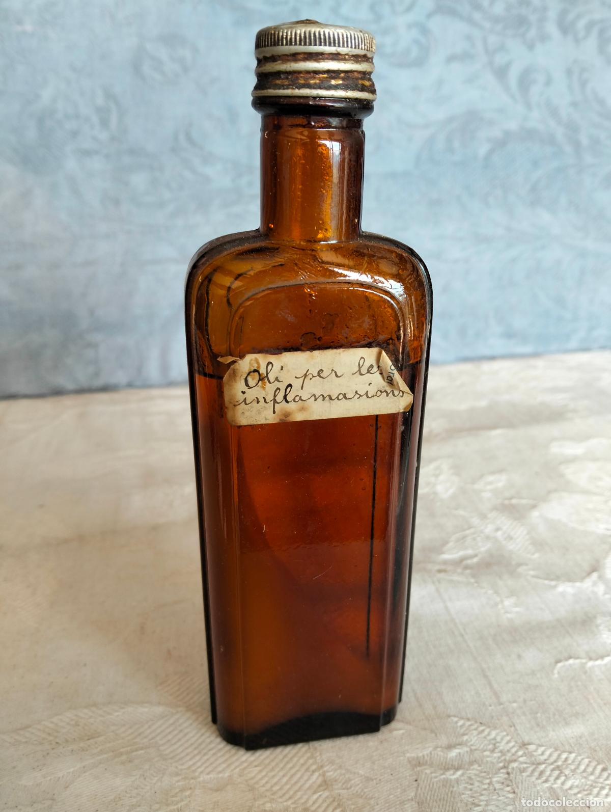 Garrafas antigas: Antigua botella de cristal marr&oacute;n frasco catal&aacute;n oli per les inflamacions medicamento a&ntilde;os 50