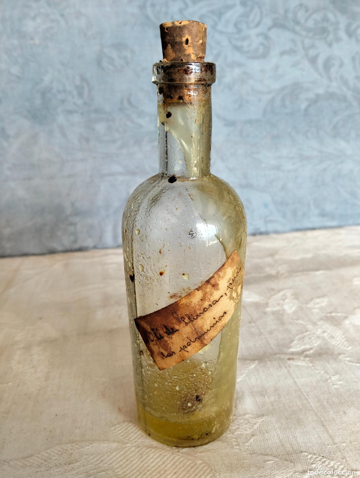 Botellas antiguas: Antigua botella de cristal transparente frasco catal&aacute;n oli de llinosa medicamento a&ntilde;os 50