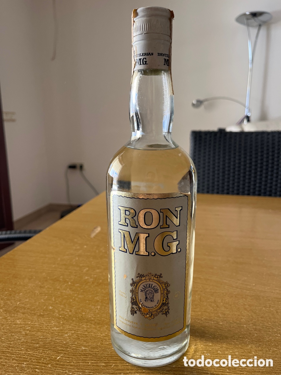 Botellas antiguas: RON M.G. - D&Eacute;CADA A&Ntilde;OS 79 - Foto 1