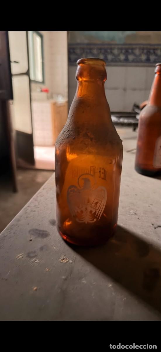 Botellas antiguas: Antiguo botell&iacute;n de cerveza El &Aacute;guila - Tercio (33 cl) - Vidrio &aacute;mbar serigrafiado - A&ntilde;os 60/70