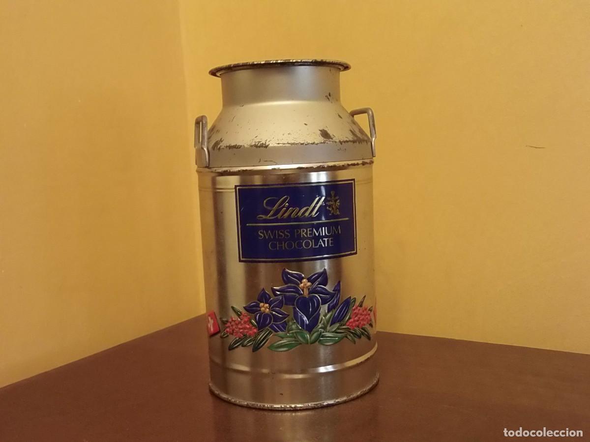 Cajas y cajitas met&aacute;licas: LECHERA DE LATA LINDT - MOTIVOS FLOREADOS Y BANDERA DE SUIZA.