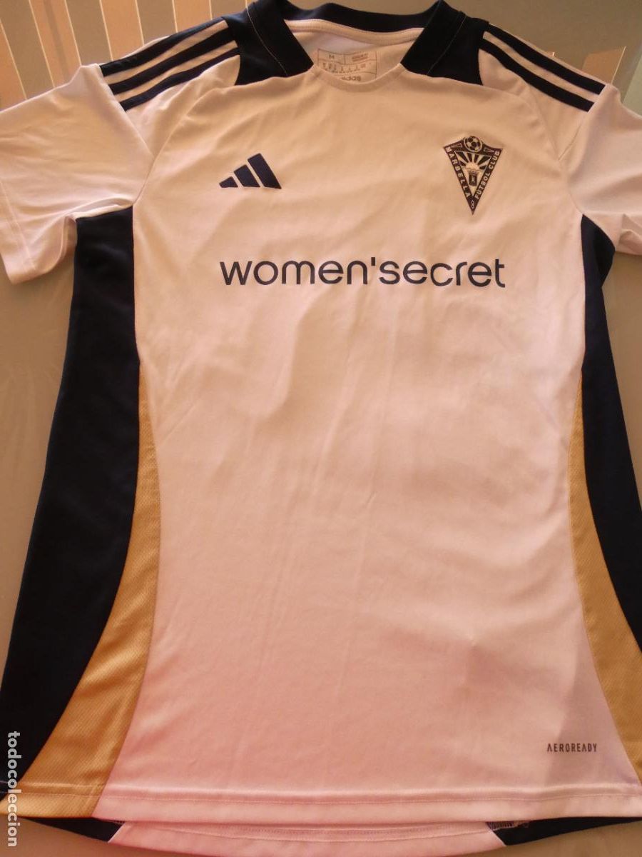 Coleccionismo deportivo: CAMISETA DE F&Uacute;TBOL MARBELLA CLUB DE F&Uacute;TBOL, M&Aacute;LAGA. WOMEN SECRET. 150GR