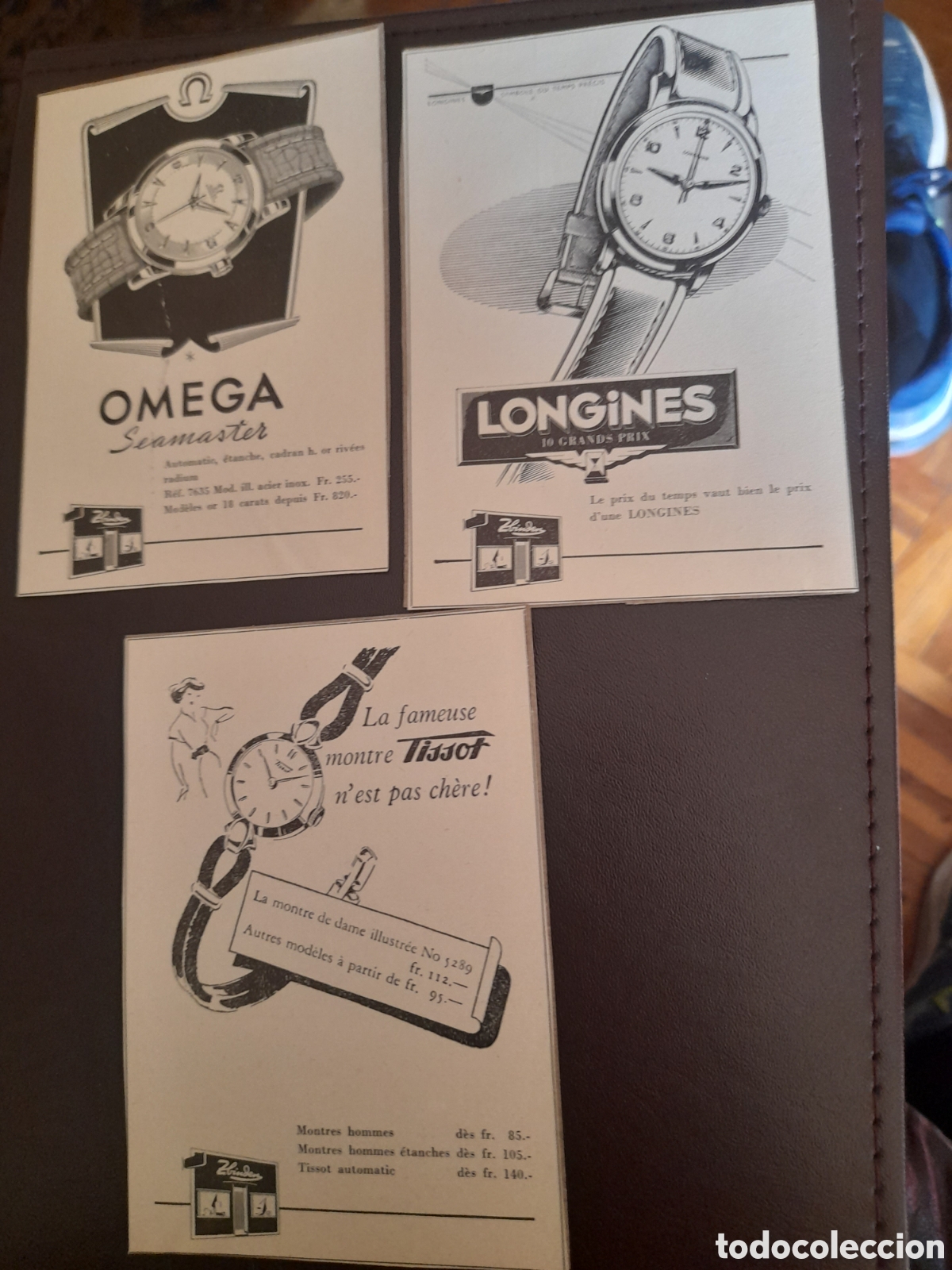 Werbekataloge: Tres antiguos anuncios publicitarios, Omega, Tissot y Longines, pegados a cartulina