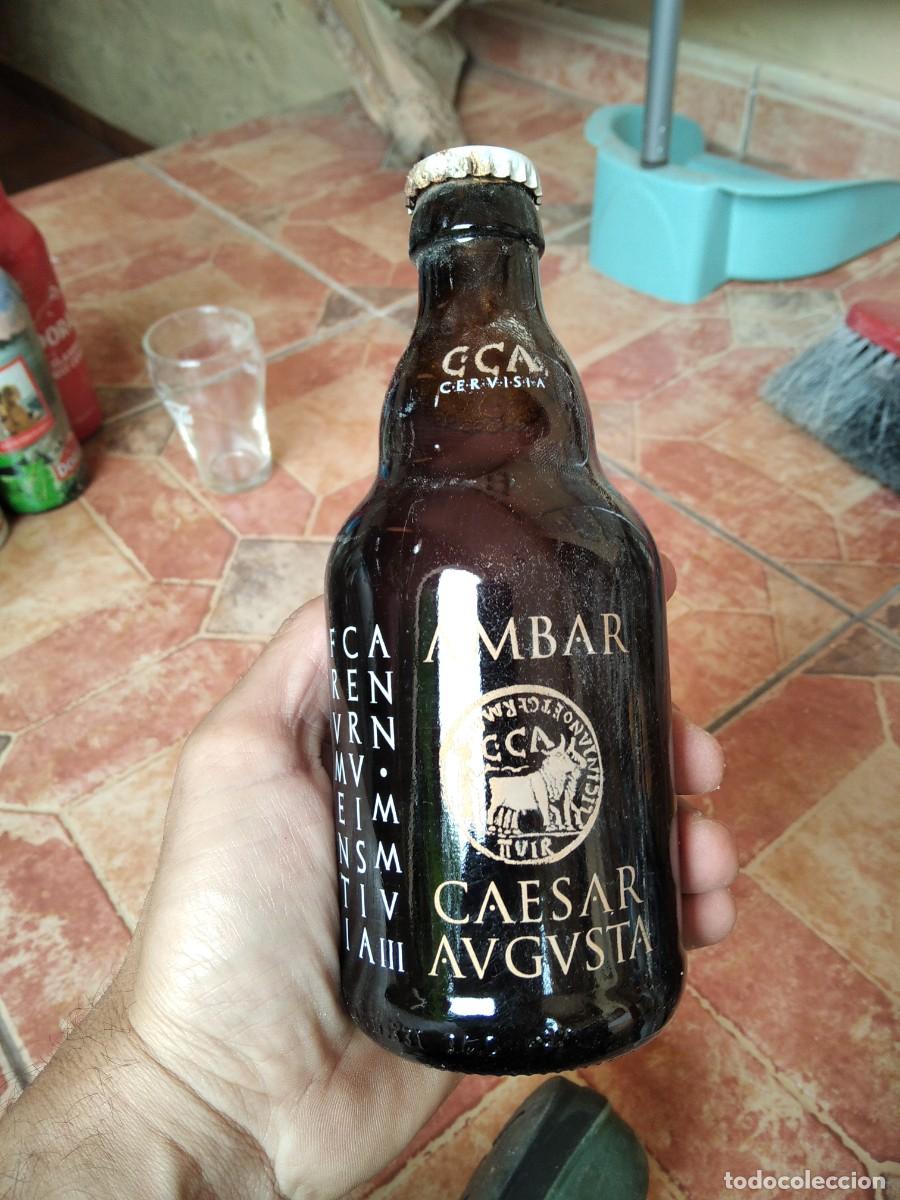 Coleccionismo de cervezas: Antigua botella Cerveza GCA Cervisia Ambar Caesar avgvsta serigrafia llena chapa corona