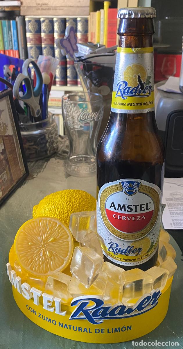 Coleccionismo de cervezas: Adorno para barra de bar publicitario de cerveza Amstel Radler. Botella real en peana de pl&aacute;stico.