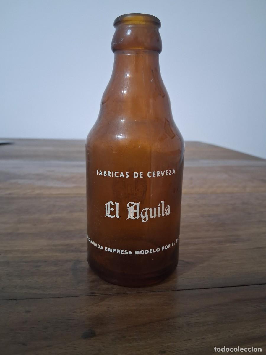 Coleccionismo de cervezas: Botella de cerveza El aguila Empresa modelo por el estado quinto