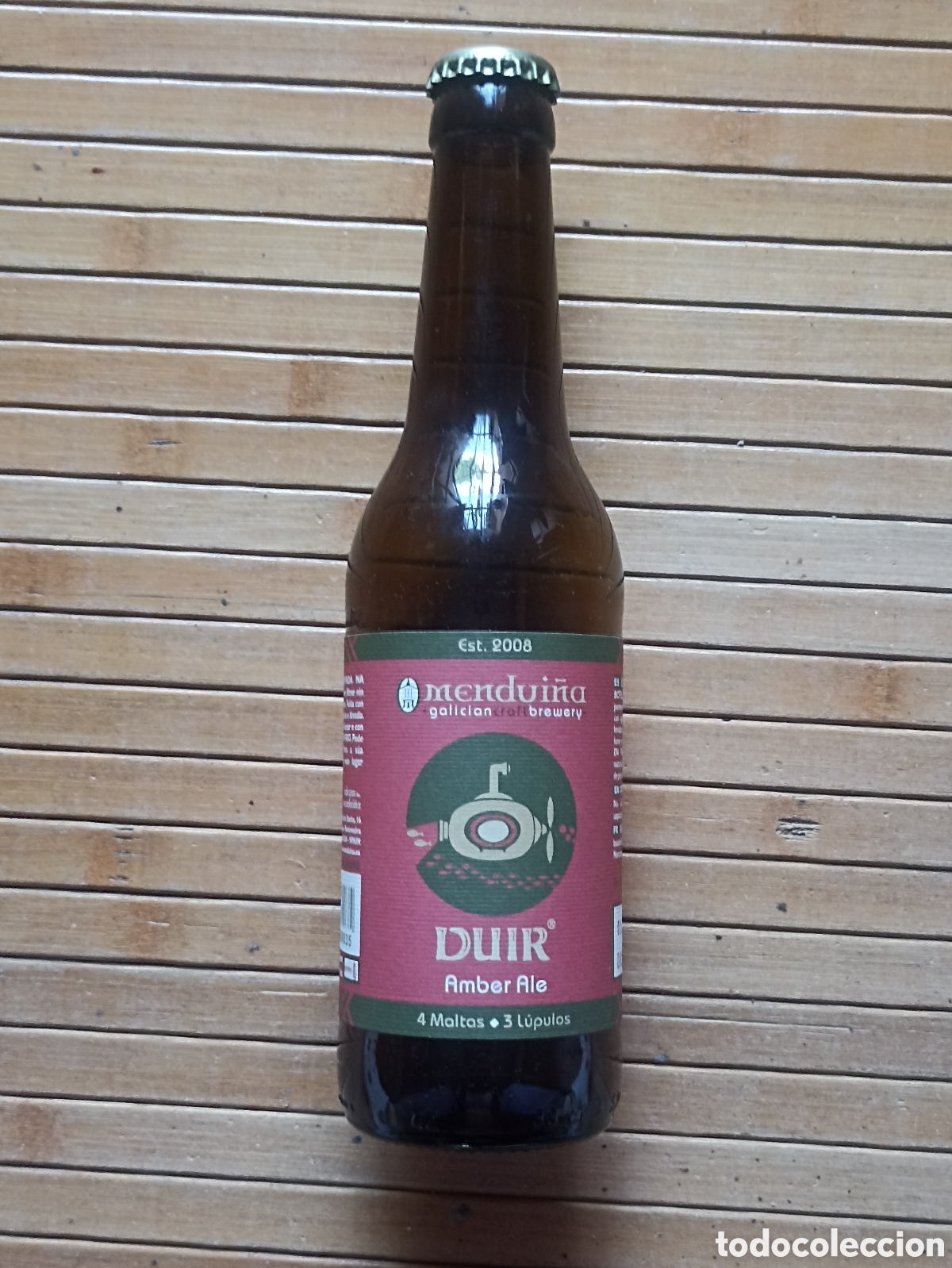 Coleccionismo de cervezas: Botella cerveza Mendui&ntilde;a Galicia vac&iacute;a con chapa 330 ml