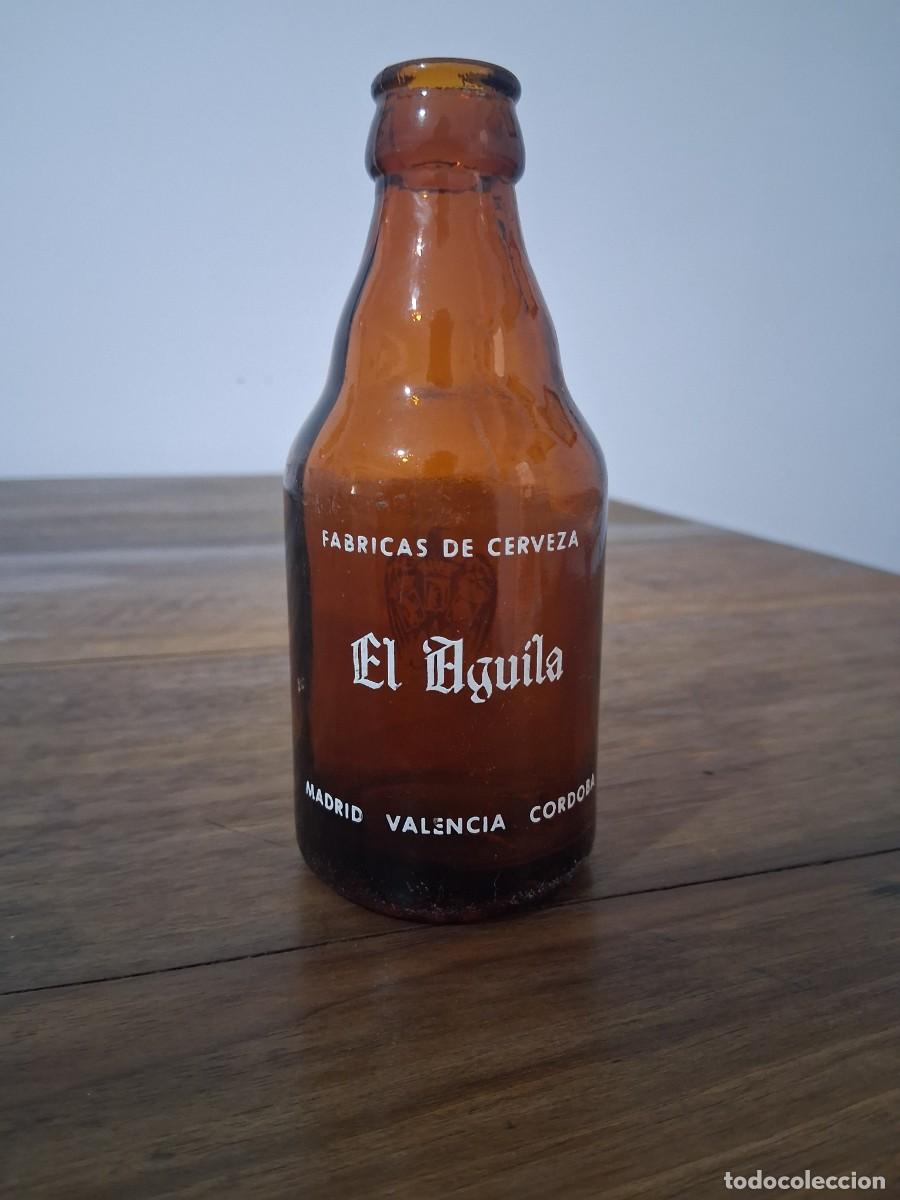 Coleccionismo de cervezas: Botella de cerveza El aguila Madrid Valencia C&oacute;rdoba