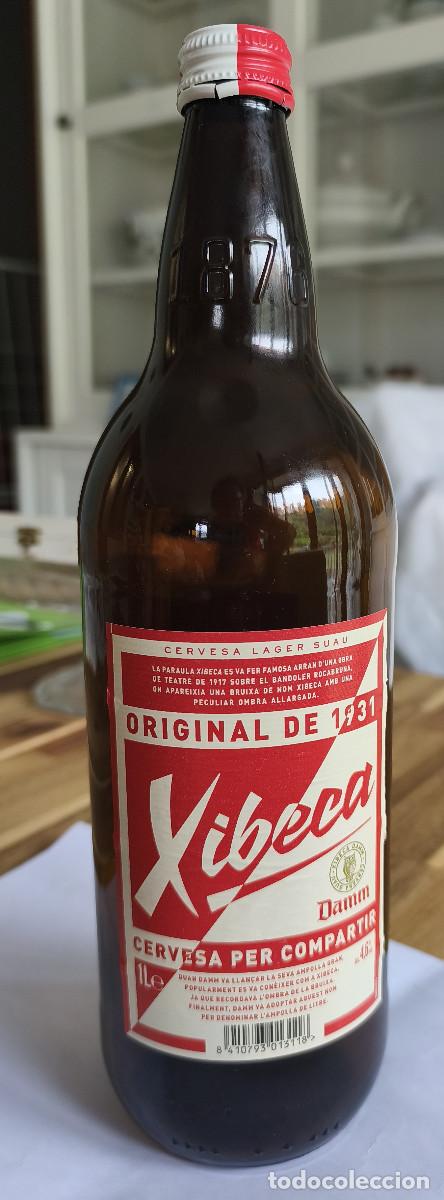Coleccionismo de cervezas: BOTELLA VACIA con etiqueta y CHAPA TAPON CORONA CERVEZA - XIBECA - DAMM Barcelona