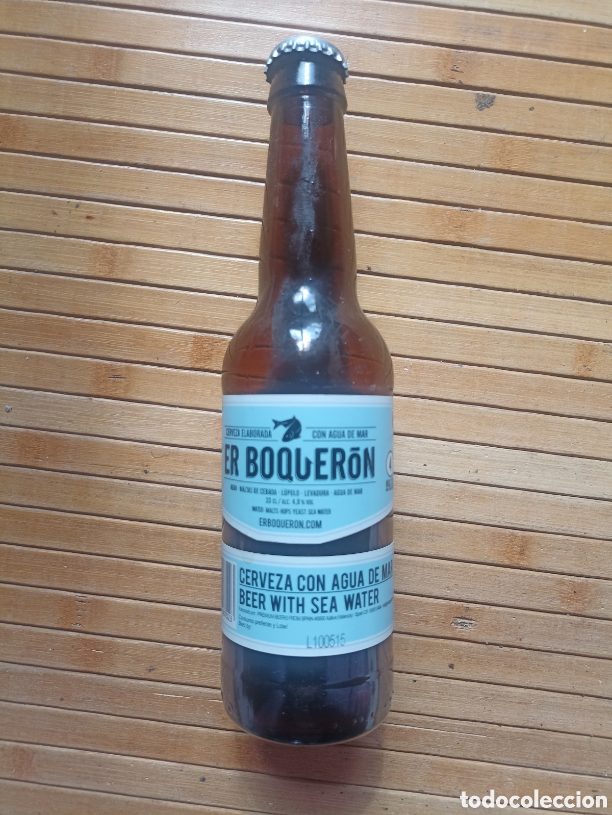 Coleccionismo de cervezas: Botella cerveza Er Boquer&oacute;n con agua de mar X&aacute;tiva Valencia vac&iacute;a con chapa 330 ml