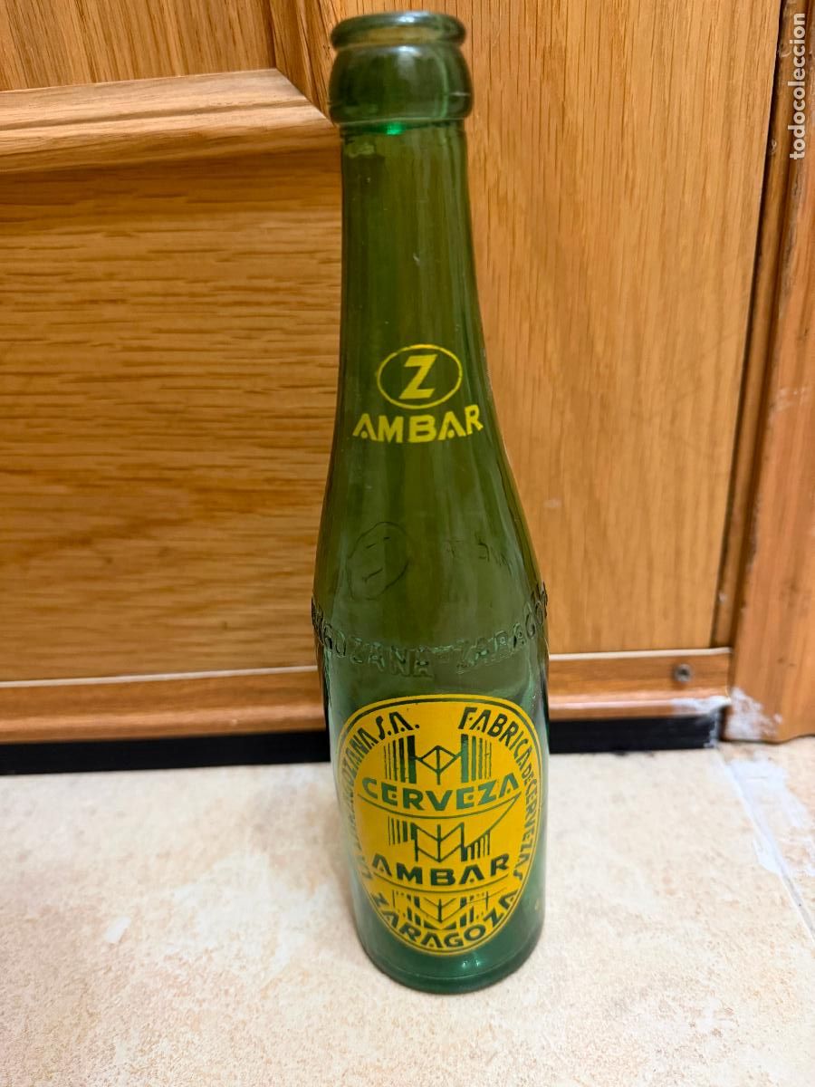 Coleccionismo de cervezas: Botella de cerveza la zaragozana verde letras en relieve 1/3