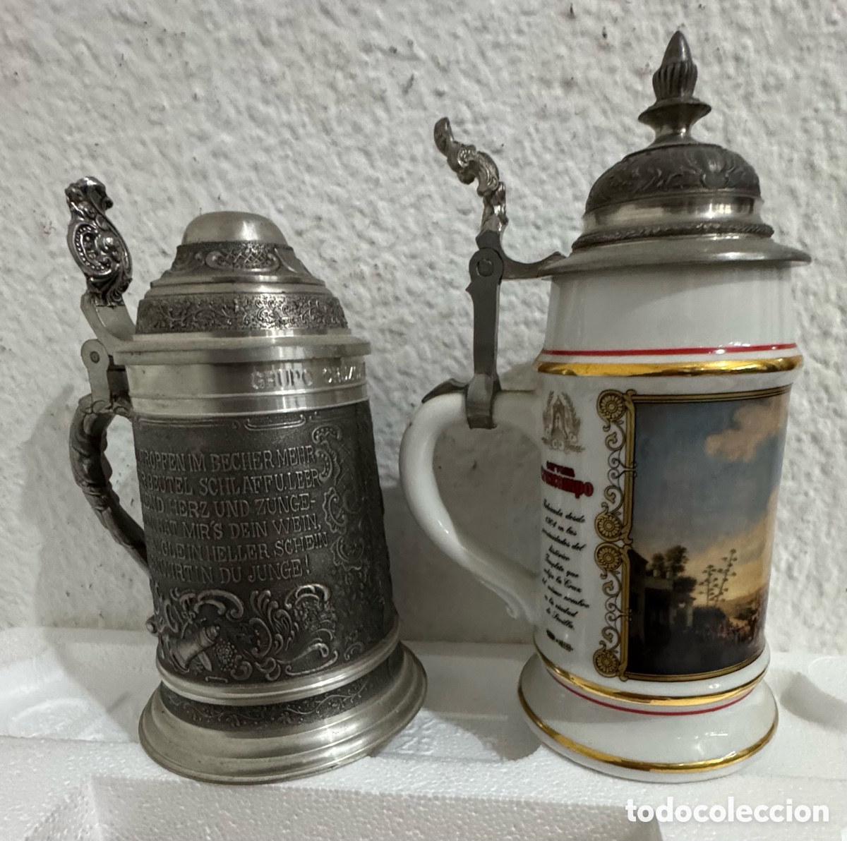 Coleccionismo de cervezas: Dos jarras Cruzcampo una de la exposici&oacute;n del 92 y otra de la formaci&oacute;n del grupo Cruzcampo