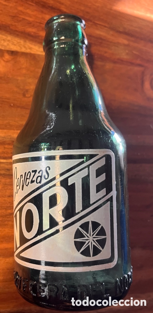 Coleccionismo de cervezas: Antigua botella serigrafia cerveza norte Bilbao relieve en base
