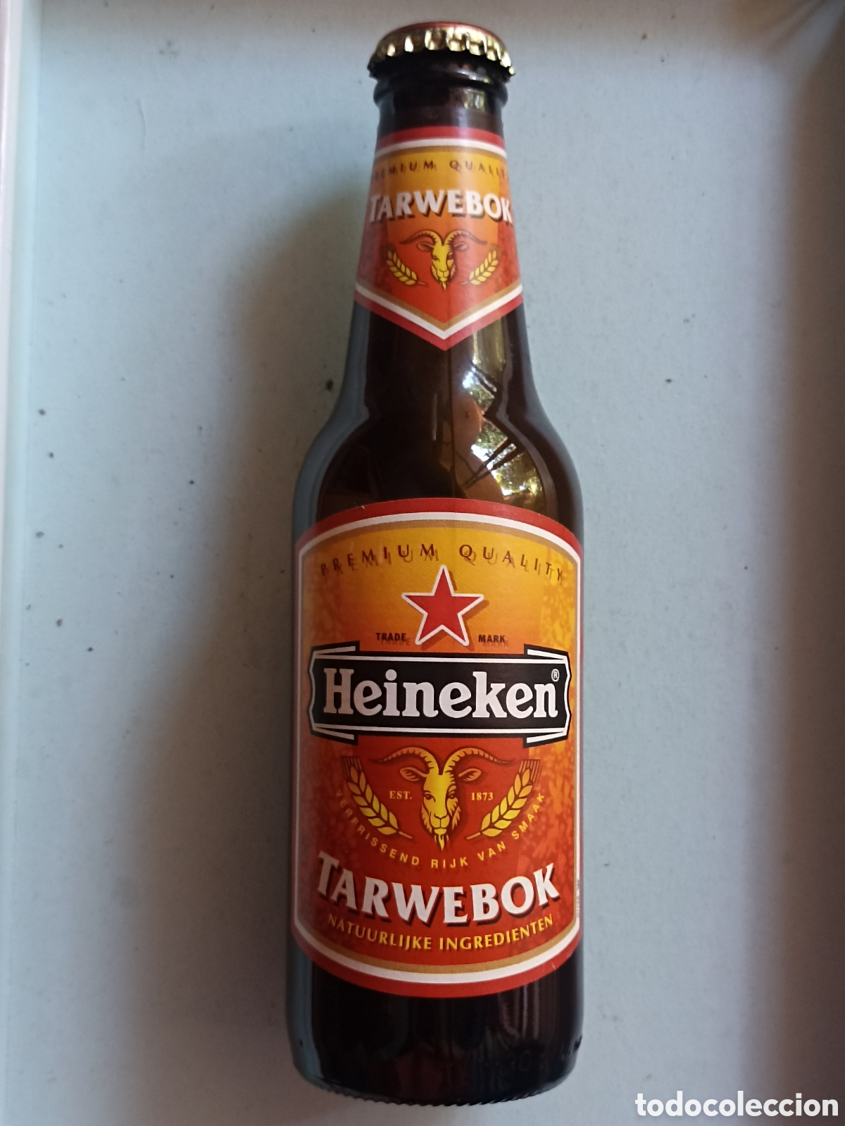 Coleccionismo de cervezas: Botella cerveza Heineken Tarwebok vac&iacute;a con chapa 300 ml