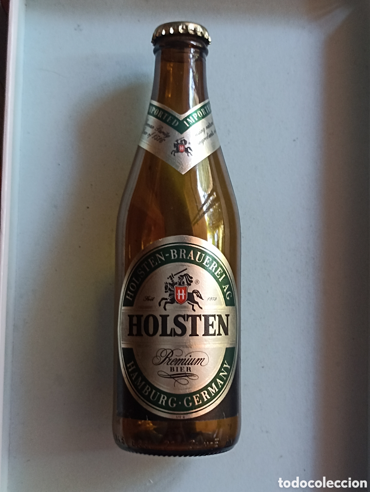 Coleccionismo de cervezas: Botella cerveza Holsten vac&iacute;a con chapa 330 ml